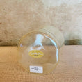 Load image into Gallery viewer, Clear Crystal Sound Bowl with a Crystal Tones label on a textured surface
