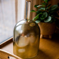 Load image into Gallery viewer, Green crystal sound practitioner bowl with a plant in the background on a wooden surface