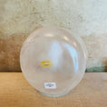 Load image into Gallery viewer, Round Crystal Sound Bowl base with a visible Crystal Tones brand label on a textured surface