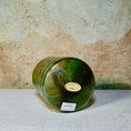 Load image into Gallery viewer, Green crystal sound bowl with a label on a textured surface
