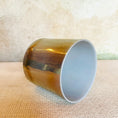 Load image into Gallery viewer, Side view of a 6-inch Crystal Tones® Charcoal Palladium Alchemy™ crystal singing bowl in G# +50, showing the reflective palladium exterior and frosted interior.