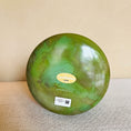 Load image into Gallery viewer, Bottomview of an 8-inch Crystal Tones® Itoigawa Jade Alchemy™ crystal singing bowl in F +45, showing its deep green marbled finish.