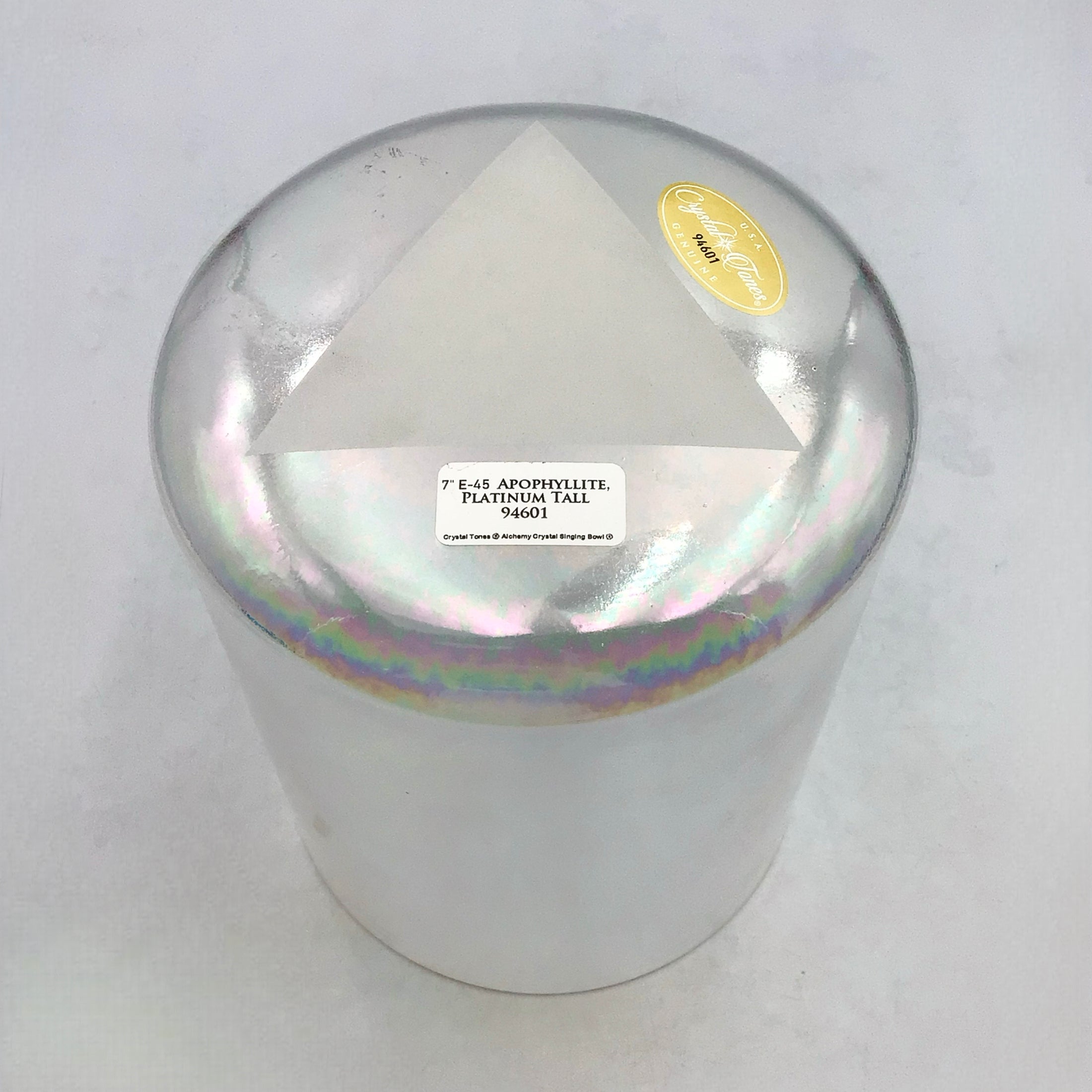 Iridescent crystal sound bowl with a label on a white background
