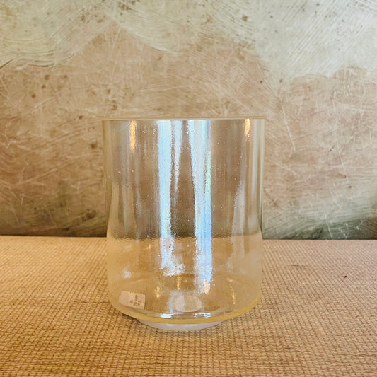 Clear Crystal Sound Bowl on a textured surface with a neutral background