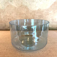 Load image into Gallery viewer, Clear crystal sound bowl on a textured surface
