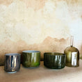 Load image into Gallery viewer, Set of four cystal sound bowls in different colours on a textured surface with a neutral background
