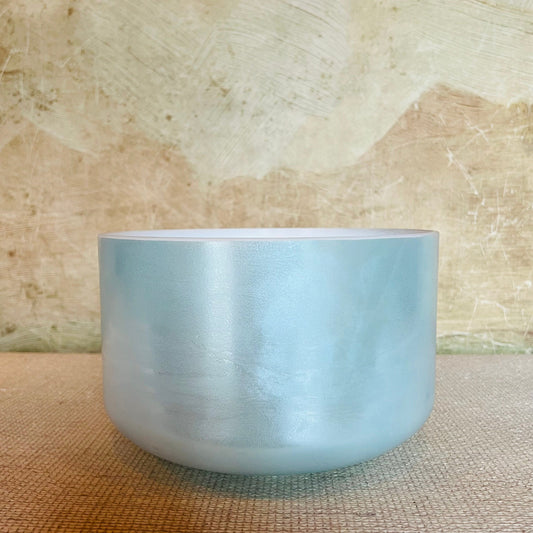 Blue Crystal Sound Bowl on a textured beige surface