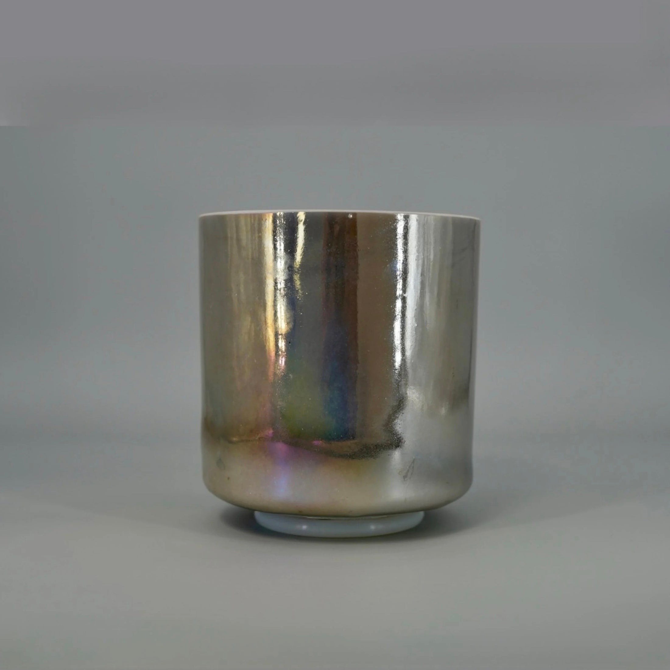 Silver metallic crystal sound bowl on a gray background