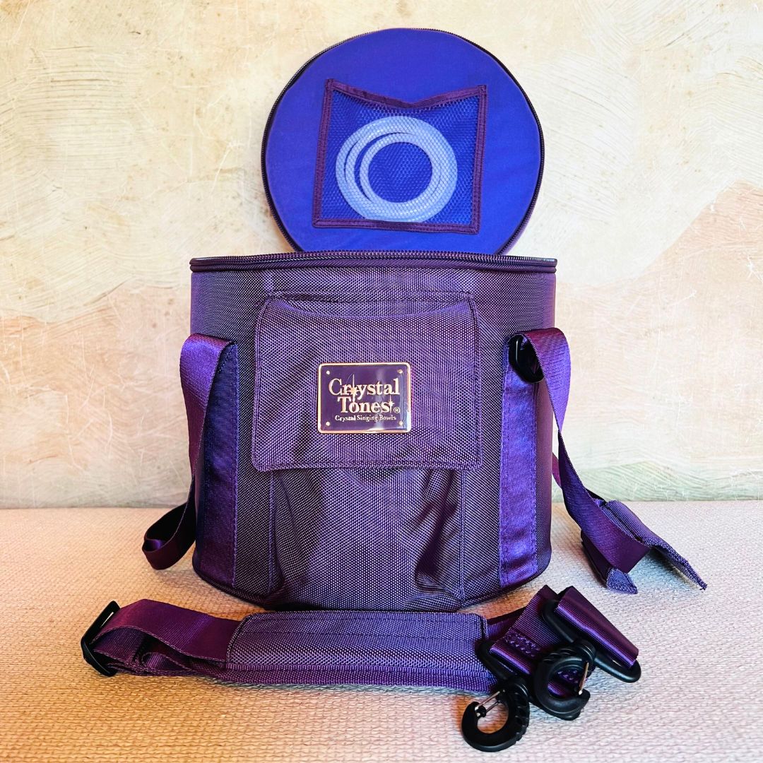 Purple crystal sound bowl carry case on a textured surface