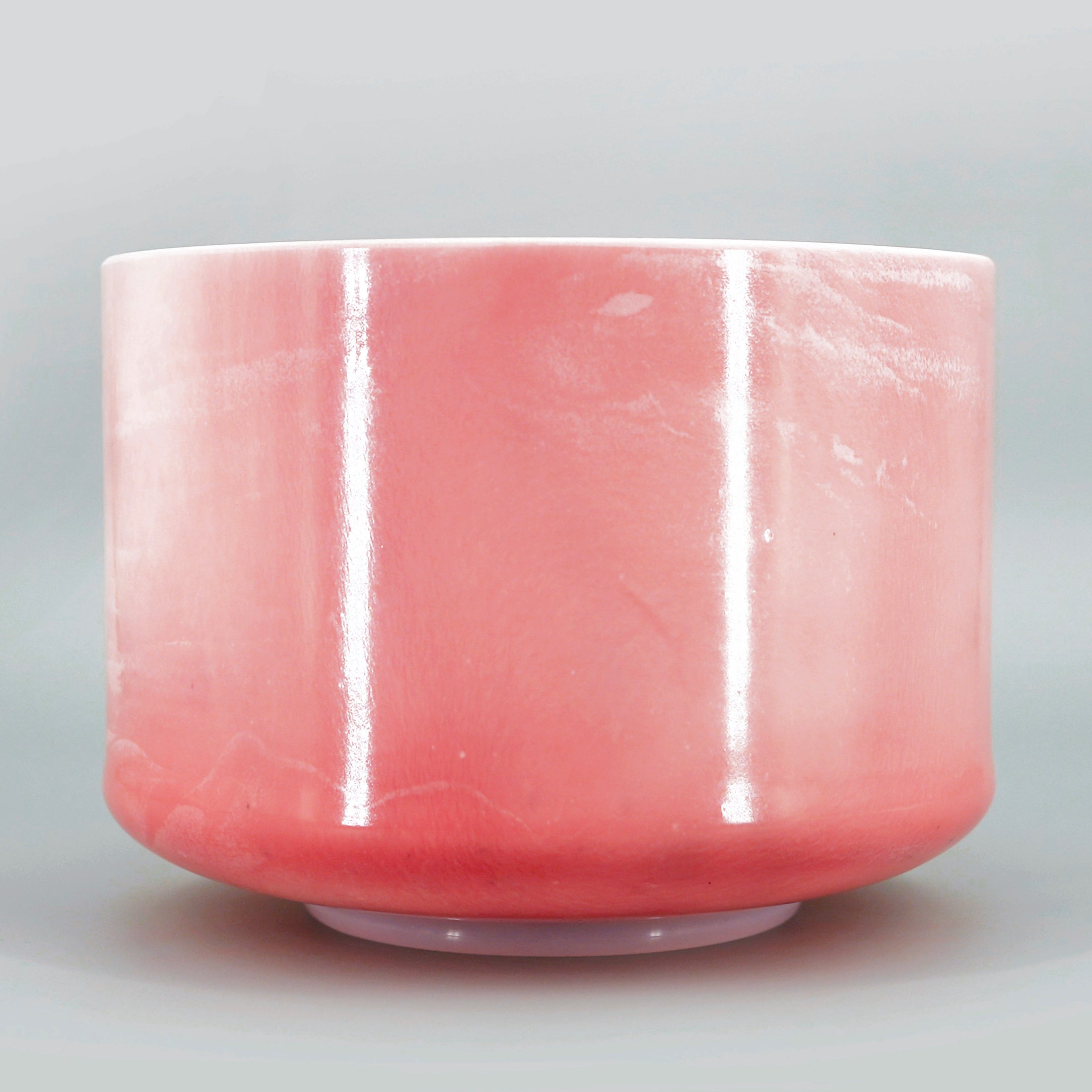 Pink crystal sound bowl on a gray background