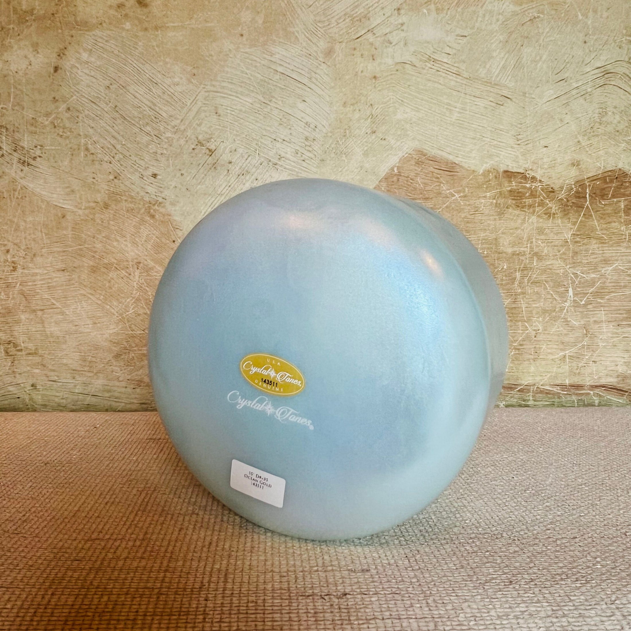 Blue Crystal Sound Bowl with a Crystal Tones brand label on a textured surface