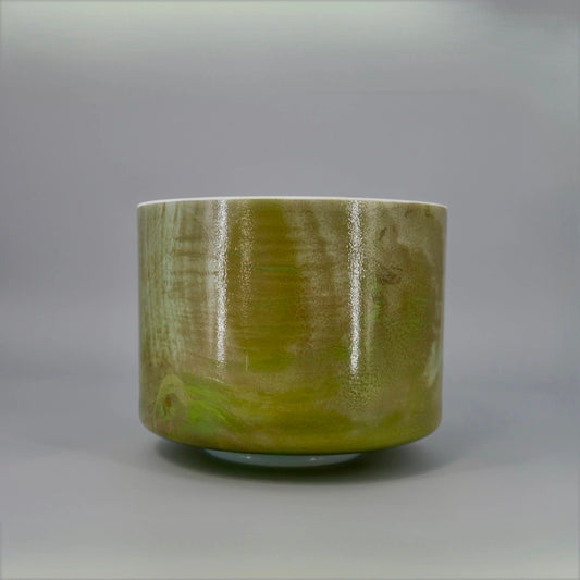 Green crystal sound bowl on a gray background