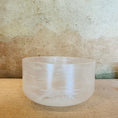 Load image into Gallery viewer, Clear crystal singing bowl on a textured surface with a neutral background
