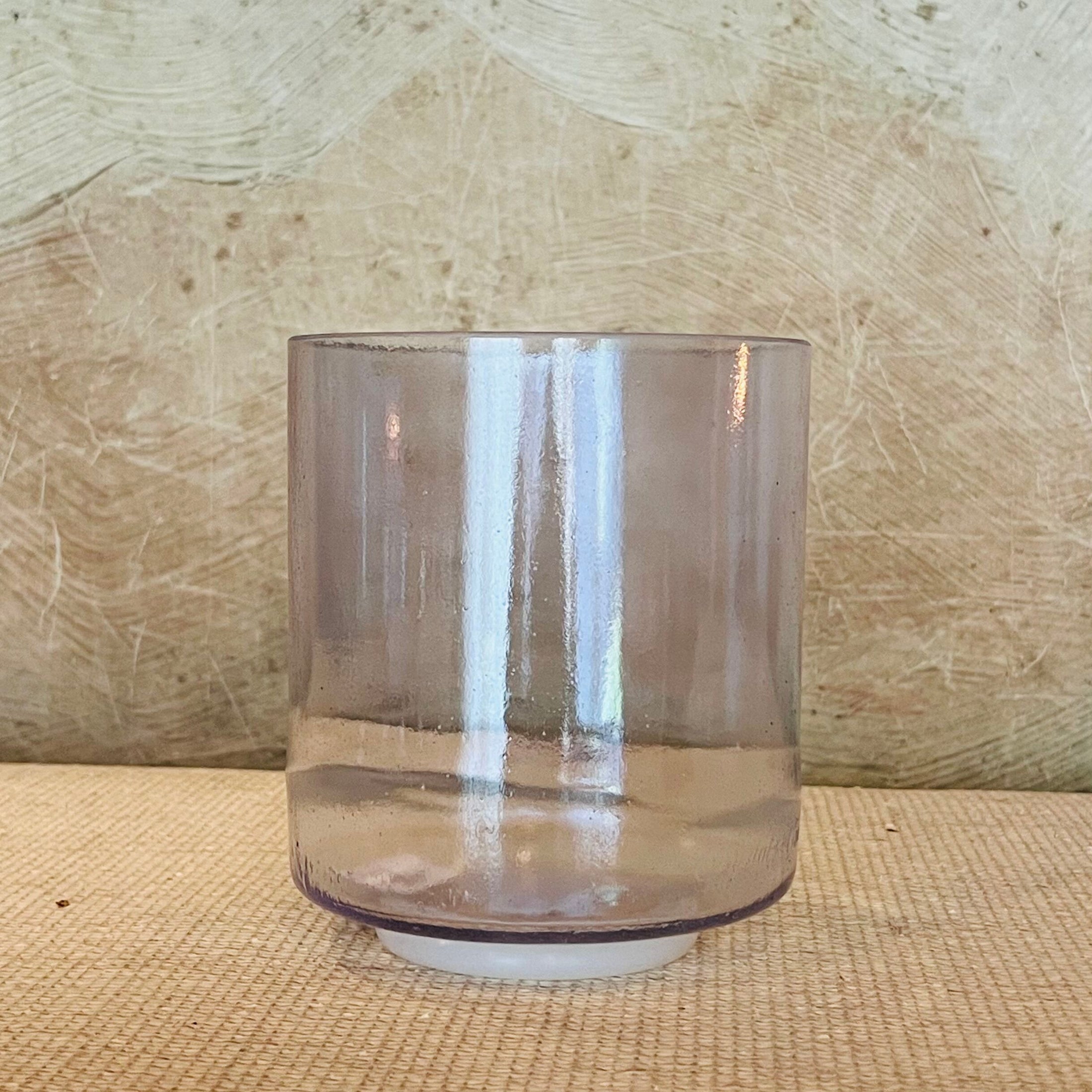 Smoky crystal sound bowl on a textured surface