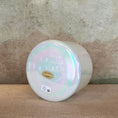 Load image into Gallery viewer, Iridescent Crystal Sound Bowl with a visible Crystal Tones brand label on a textured surface
