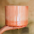 Load image into Gallery viewer, Hand holding a pink crystal singing bowl with 'Crystal Tones' branding on a blurred background
