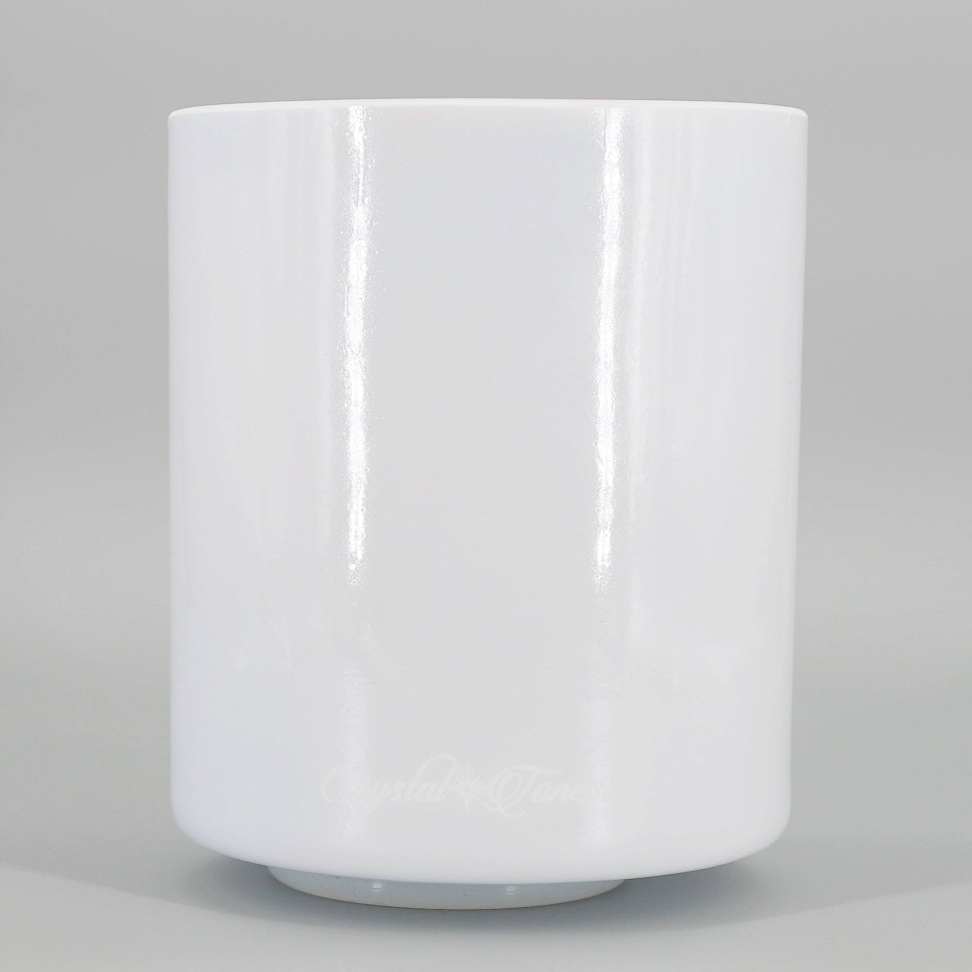 White crystal sound bowl on a gray background