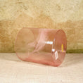 Load image into Gallery viewer, Clear pink crystal sound bowl with a Crystal Tones label on a textured surface
