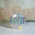 Load image into Gallery viewer, Iridescent crystal sound bowl with a design on a textured surface
