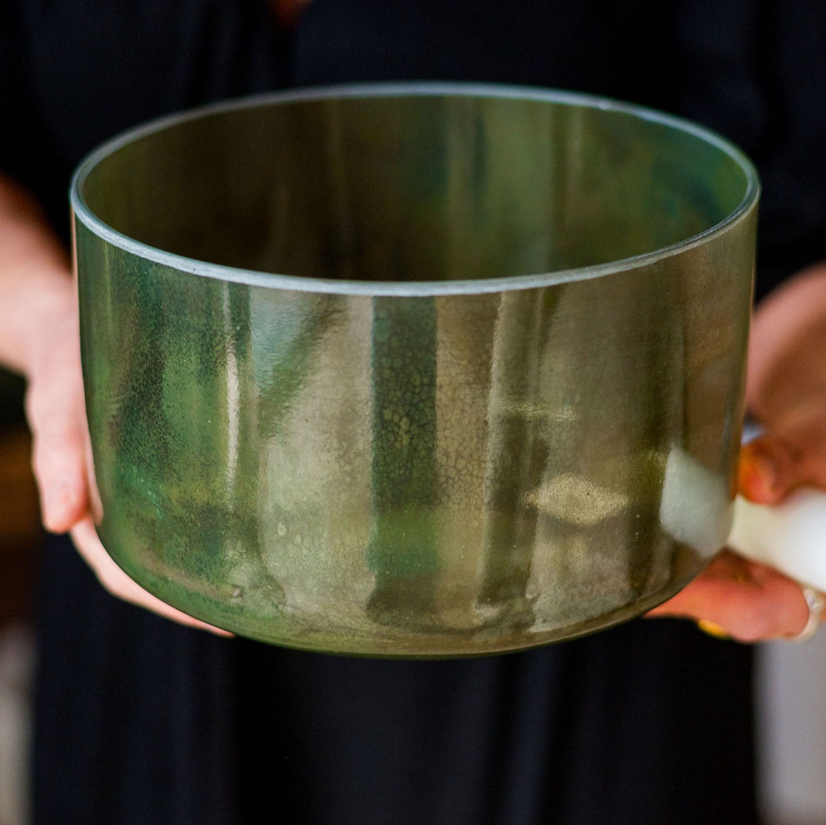 9-inch Crystal Tones® Chrysoprase Alchemy™ crystal singing bowl in C# +35, held in hand.