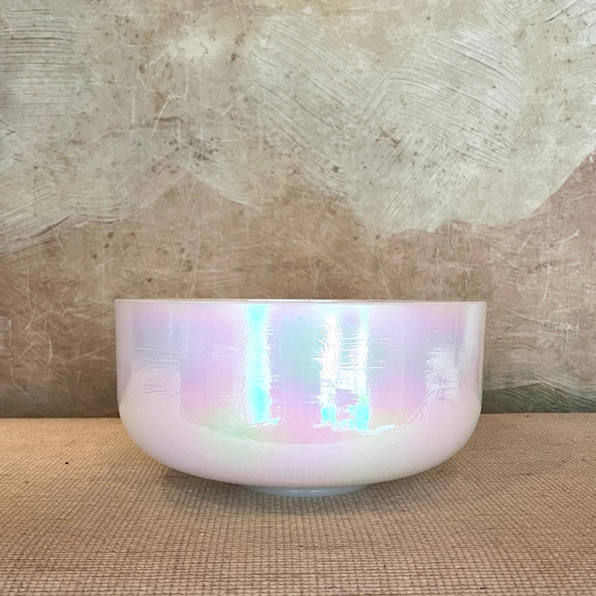 Front view of a 12-inch Crystal Tones® Mother of Platinum Alchemy™ crystal singing bowl in D +45.background