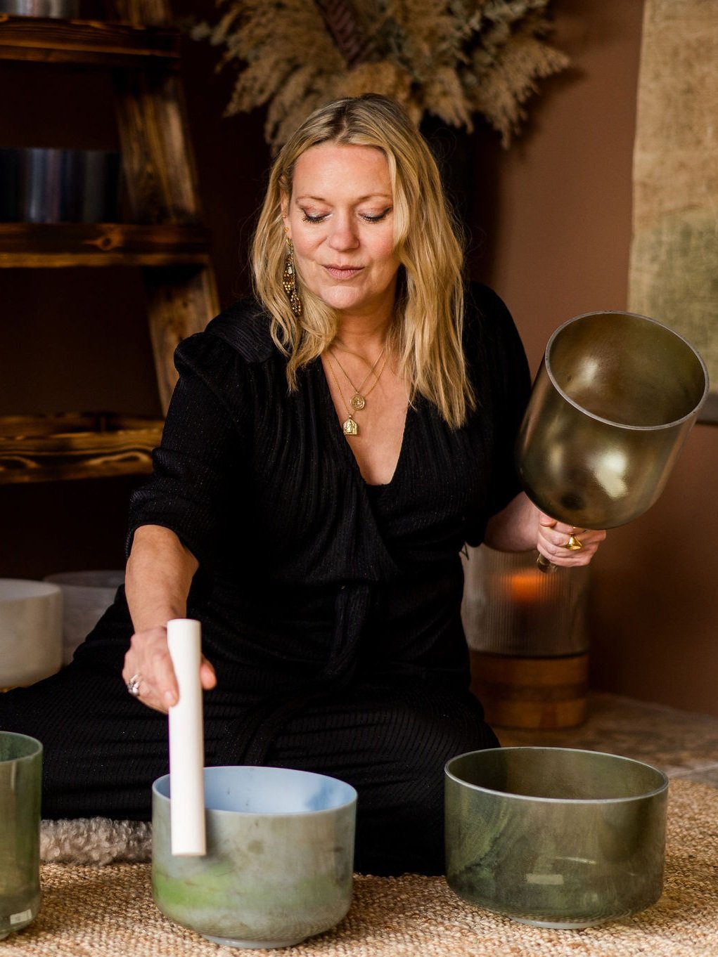 Kate playing with singing bowls in a room with decorative elements